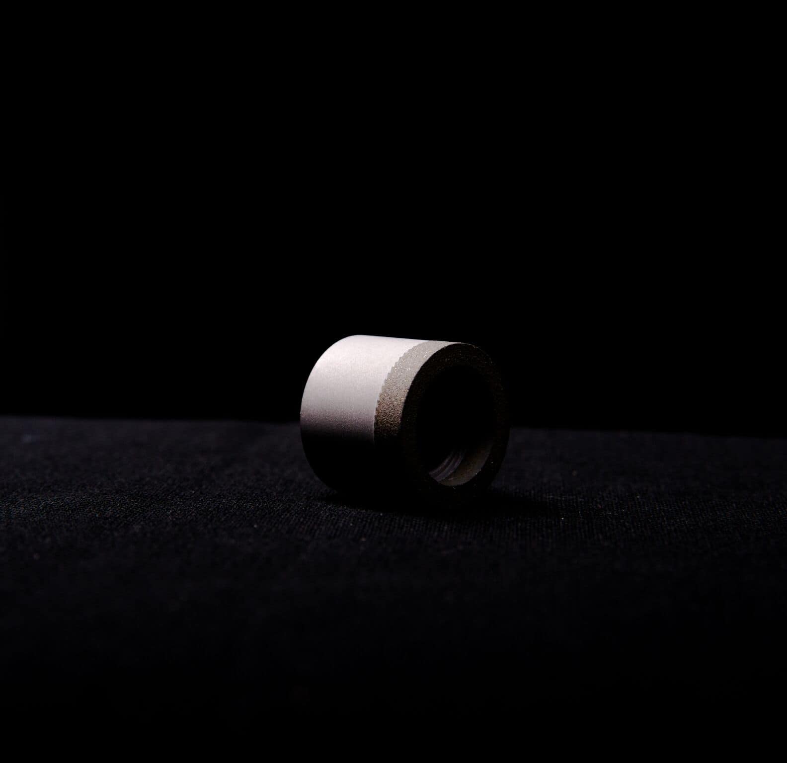 a white tube sitting on a black surface